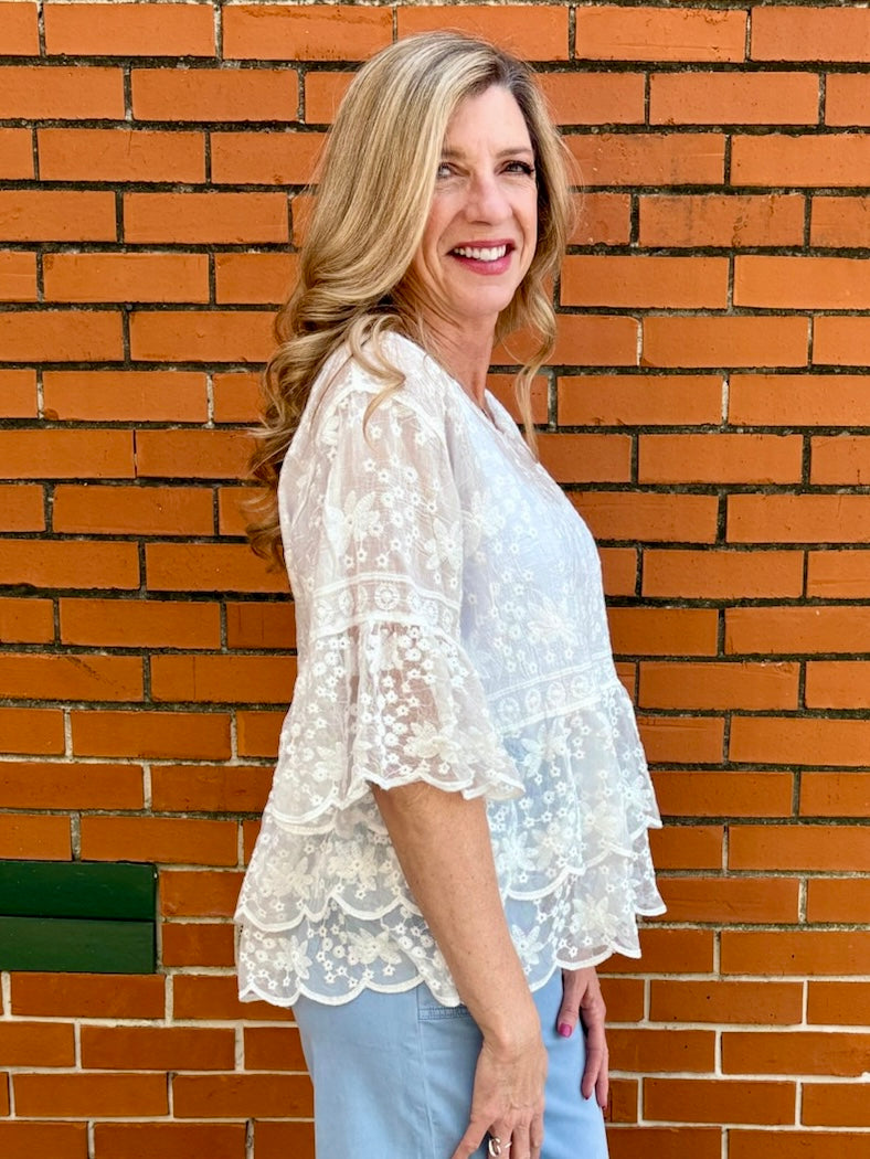 White Lace blouse, cotton boho top, bell sleeve shirt, floral embroidery top, scalloped hem blouse, feminine V-neck top, tiered lace top, bohemian fashion, white lace blouse, black vintage style top. at ooh la la! in Grapevine TX 76051