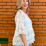 White Lace blouse, cotton boho top, bell sleeve shirt, floral embroidery top, scalloped hem blouse, feminine V-neck top, tiered lace top, bohemian fashion, white lace blouse, black vintage style top. at ooh la la! in Grapevine TX 76051