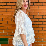 White Lace blouse, cotton boho top, bell sleeve shirt, floral embroidery top, scalloped hem blouse, feminine V-neck top, tiered lace top, bohemian fashion, white lace blouse, black vintage style top. at ooh la la! in Grapevine TX 76051