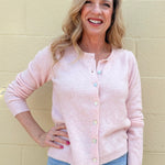 pink soft knit cardigan, women's crewneck cardigan, button down sweater, pastel knitwear, lightweight layering piece, classic women's sweater, pearl button cardigan, spring knitwear staples.
at ooh la la in Grapevine TX 76051