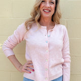 pink soft knit cardigan, women's crewneck cardigan, button down sweater, pastel knitwear, lightweight layering piece, classic women's sweater, pearl button cardigan, spring knitwear staples.
at ooh la la in Grapevine TX 76051