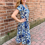 Dress Addict Jazy, organic cotton midi dress, blue floral dress with pockets, sustainable summer dress, bias cut v-neck dress, women's tiered floral midi, travel-friendly crinkle dress. at ooh la la! in Grapevine TX 76051