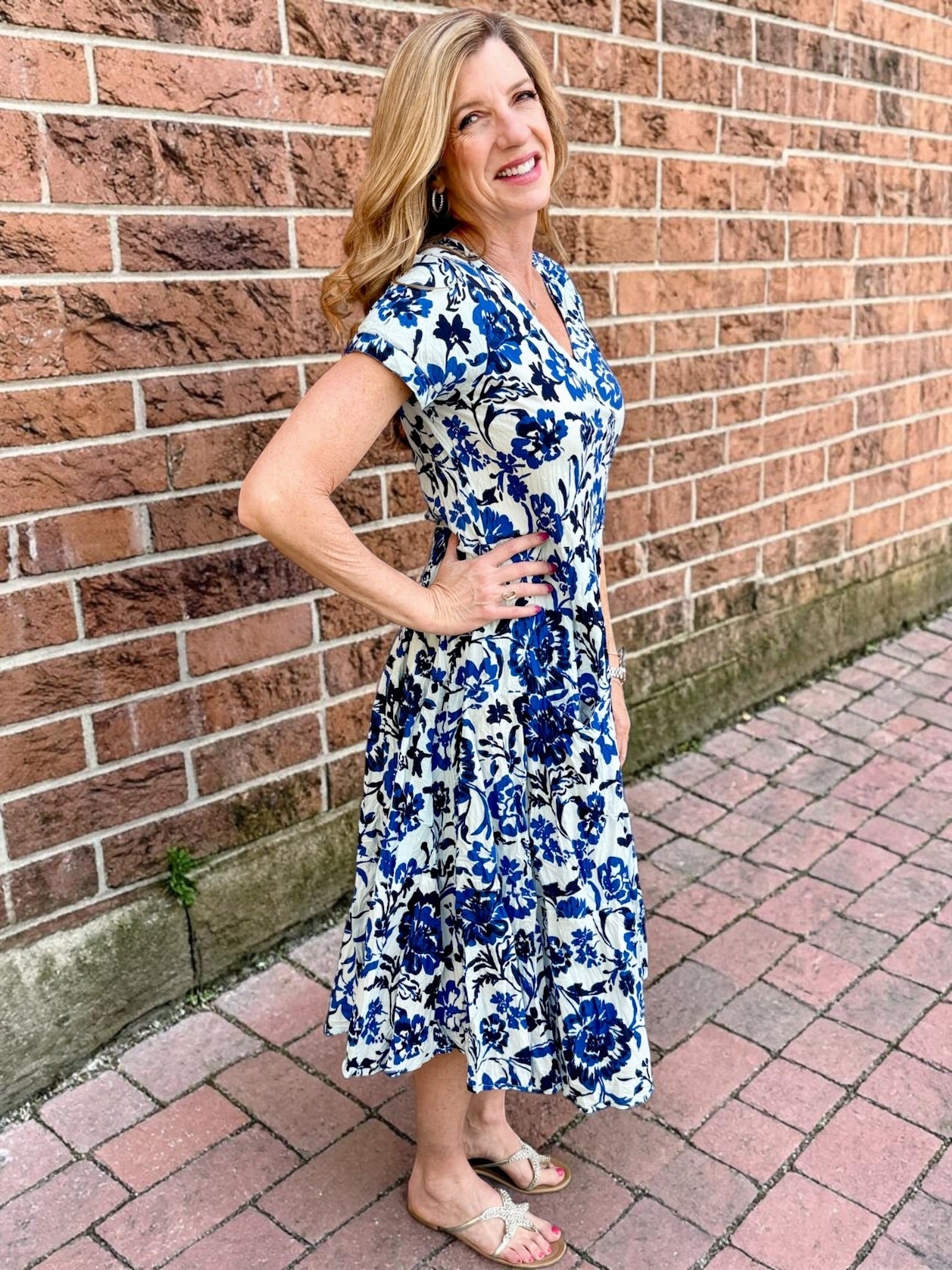 Dress Addict Jazy, organic cotton midi dress, blue floral dress with pockets, sustainable summer dress, bias cut v-neck dress, women's tiered floral midi, travel-friendly crinkle dress. at ooh la la! in Grapevine TX 76051