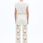 off white floral cutout jeans, embroidered straight leg pants, women's cream denim, high rise relaxed jeans, boho lace pants, luxury embroidered denim, off white floral trousers at ooh la la in Grapevine TX 76051