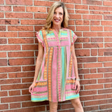 Boho beach dress, neon summer dress, flutter sleeve mini, geometric print dress, tassel trim dress, resort wear for women, cotton v-neck dress, vacation outfits, colorful sun dress. at ooh la la! in Grapevine TX 76051