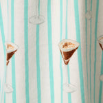 Close-up of flannel fabric with espresso martini print on aqua striped pool blue background
