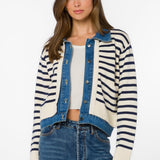 Woman wearing ivory and navy striped cardigan jacket with denim blue trim
