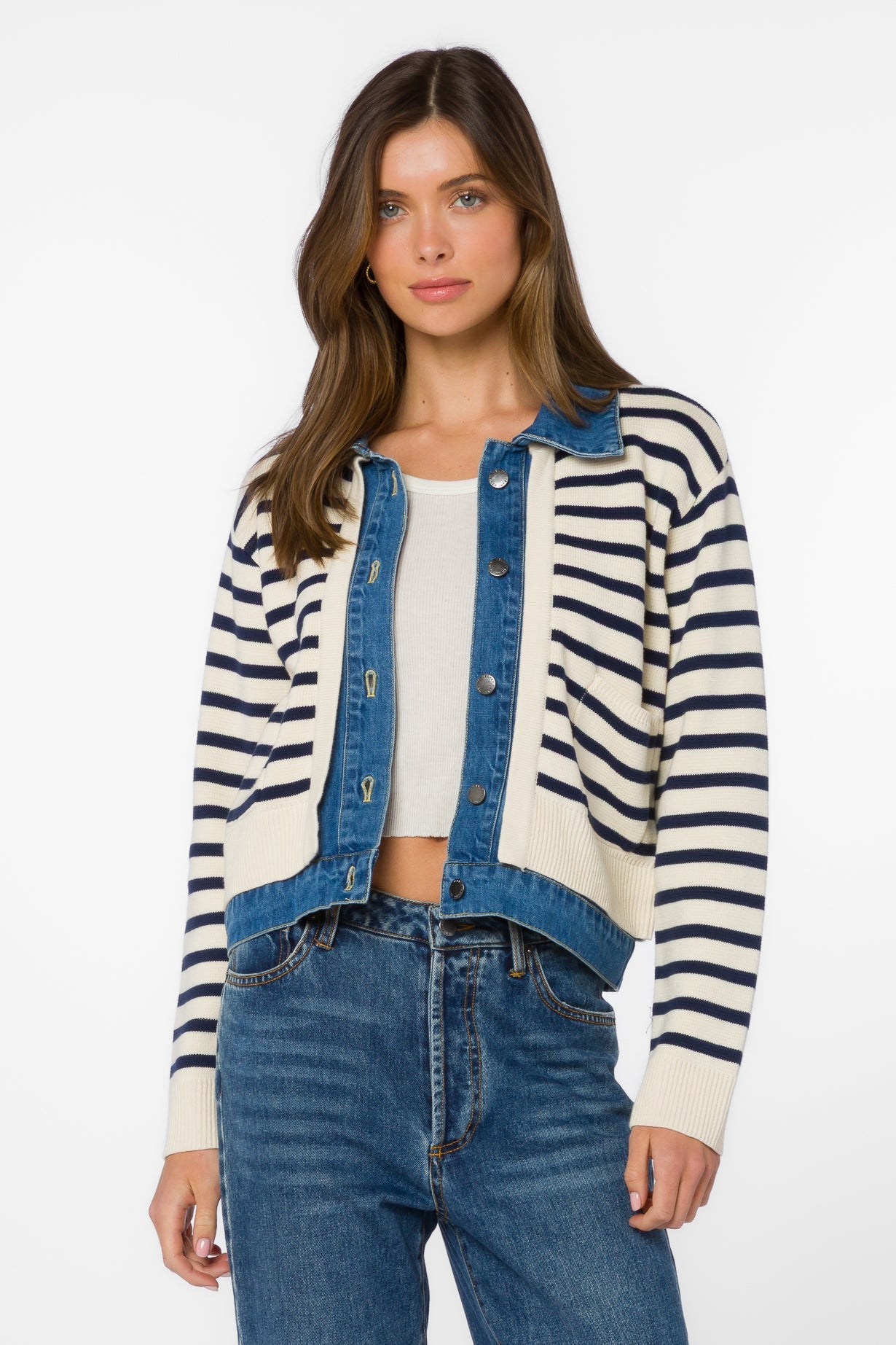 Woman wearing ivory and navy striped cardigan jacket with denim blue trim