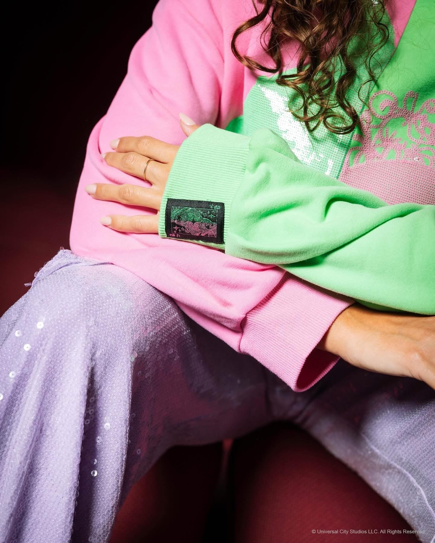 Wicked X Queen of Sparkles Green & Pink Colorblock Character Profile 'Wicked' Sweatshirt at ooh la la! in Grapevine TX 76051