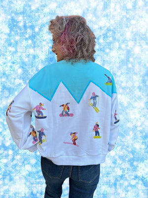 Queen of Sparkles White/Blue Skiers on Mountain Sweatshirt at ooh la la! in Grapevine TX 76051