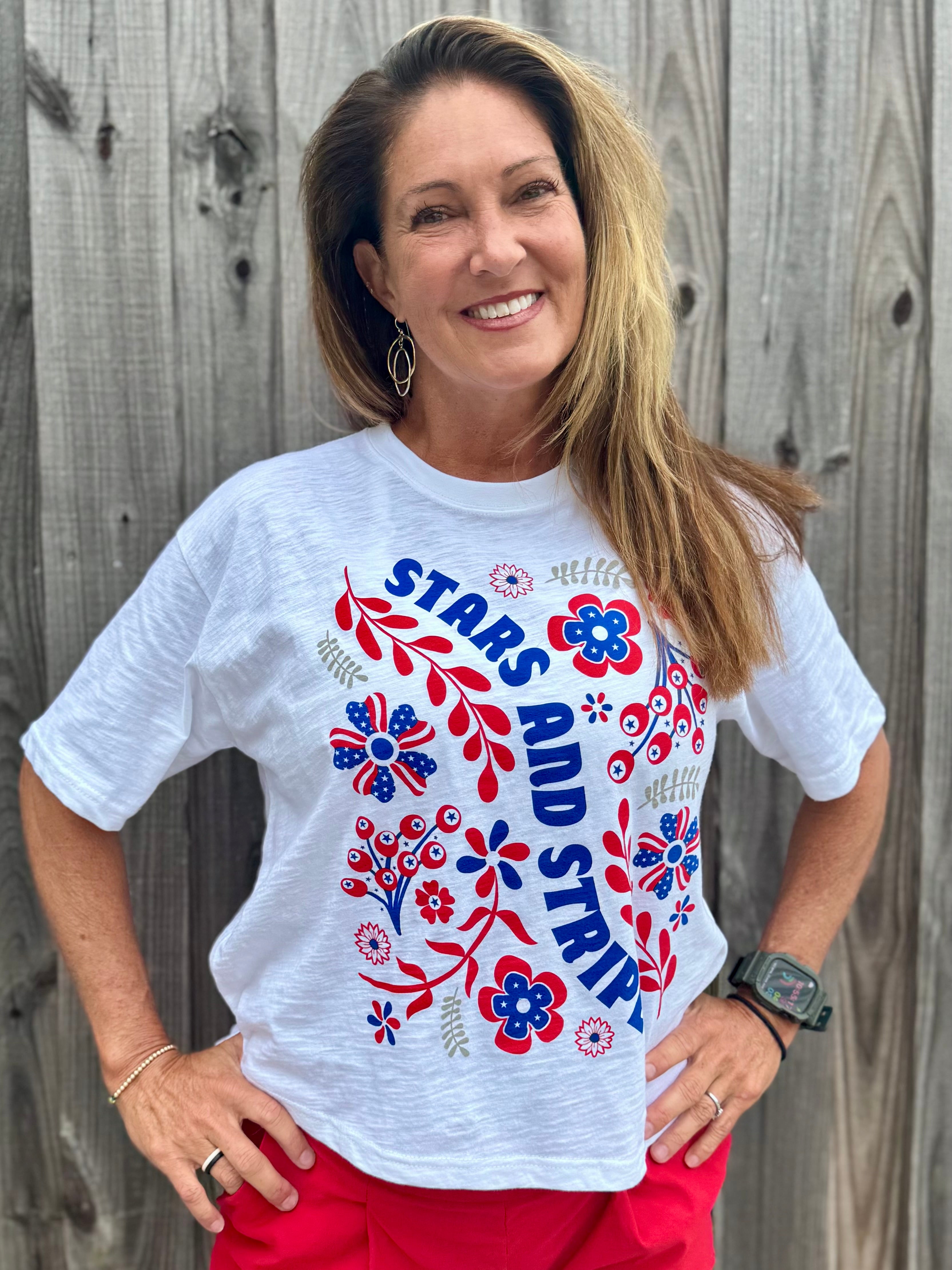 Patriotic Women's Apparel, Americana Tee, 4th of July Shirt, Floral Stars and Stripes, Premium Slub Cotton, Women's Graphic Tee, Red White and Blue Fashion, Summer Patriotic Tops. at ooh la la! in Grapevine TX 76051