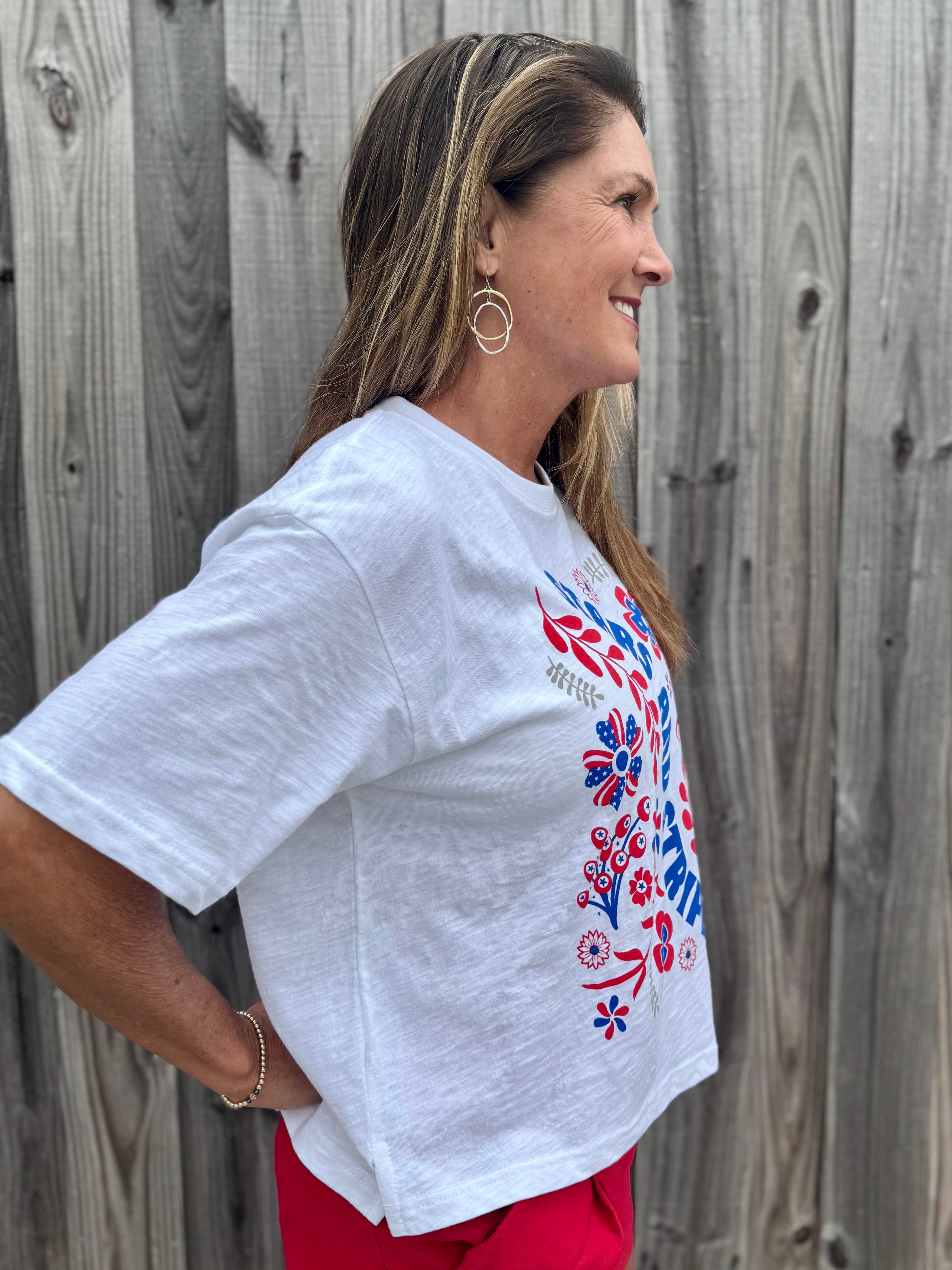 Patriotic Women's Apparel, Americana Tee, 4th of July Shirt, Floral Stars and Stripes, Premium Slub Cotton, Women's Graphic Tee, Red White and Blue Fashion, Summer Patriotic Tops. at ooh la la! in Grapevine TX 76051