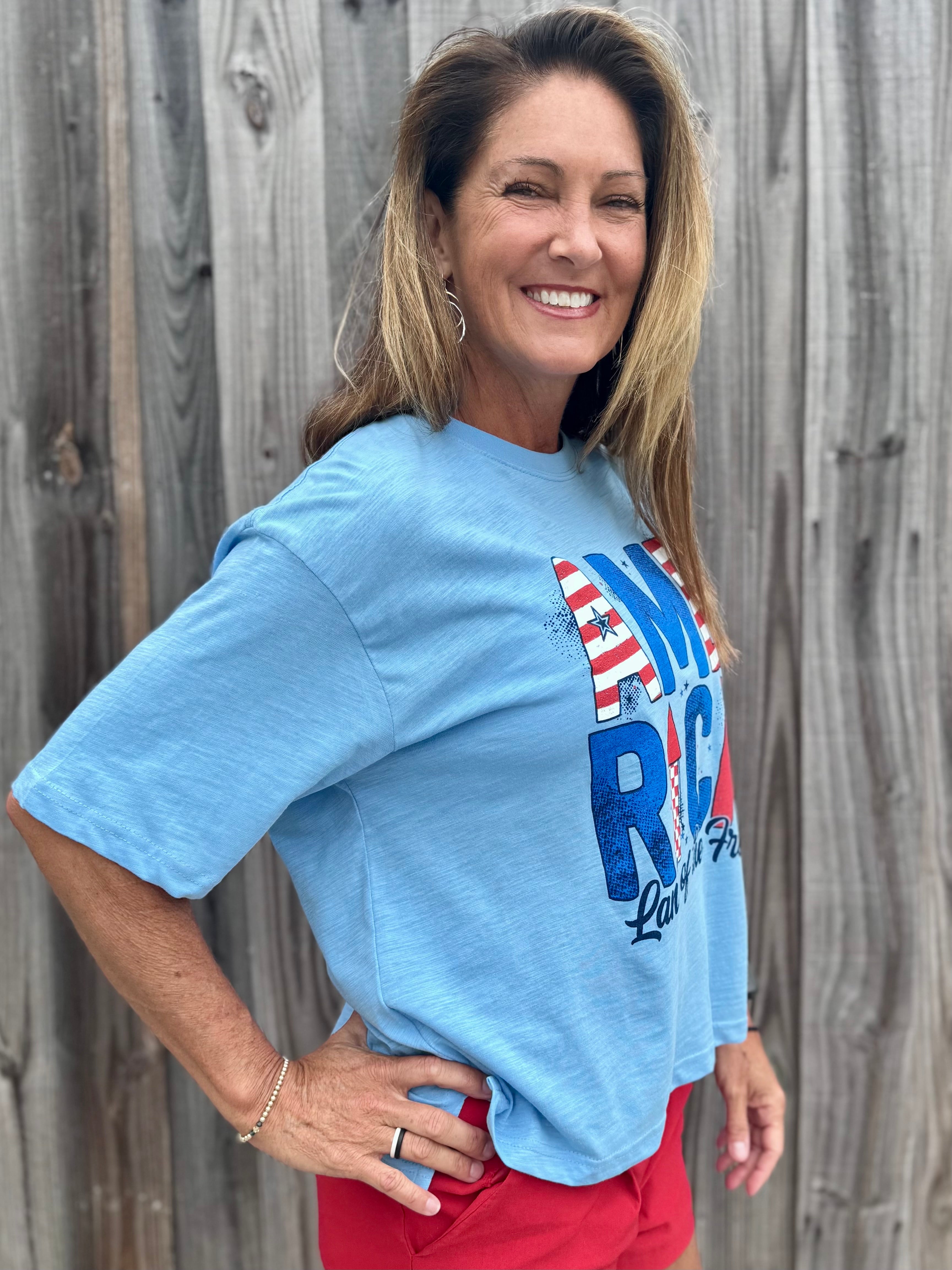 Patriotic graphic tee, slub cotton shirt, 4th of July outfit, American flag t-shirt, boxy fit cotton tee, Land of the Free shirt, women’s patriotic apparel, textured cotton t-shirt. at ooh la la! in Grapevine TX 76051