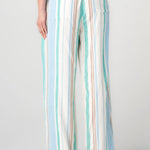 Woman wearing striped wide leg pull-on pants in cream, teal, and blue vertical stripes