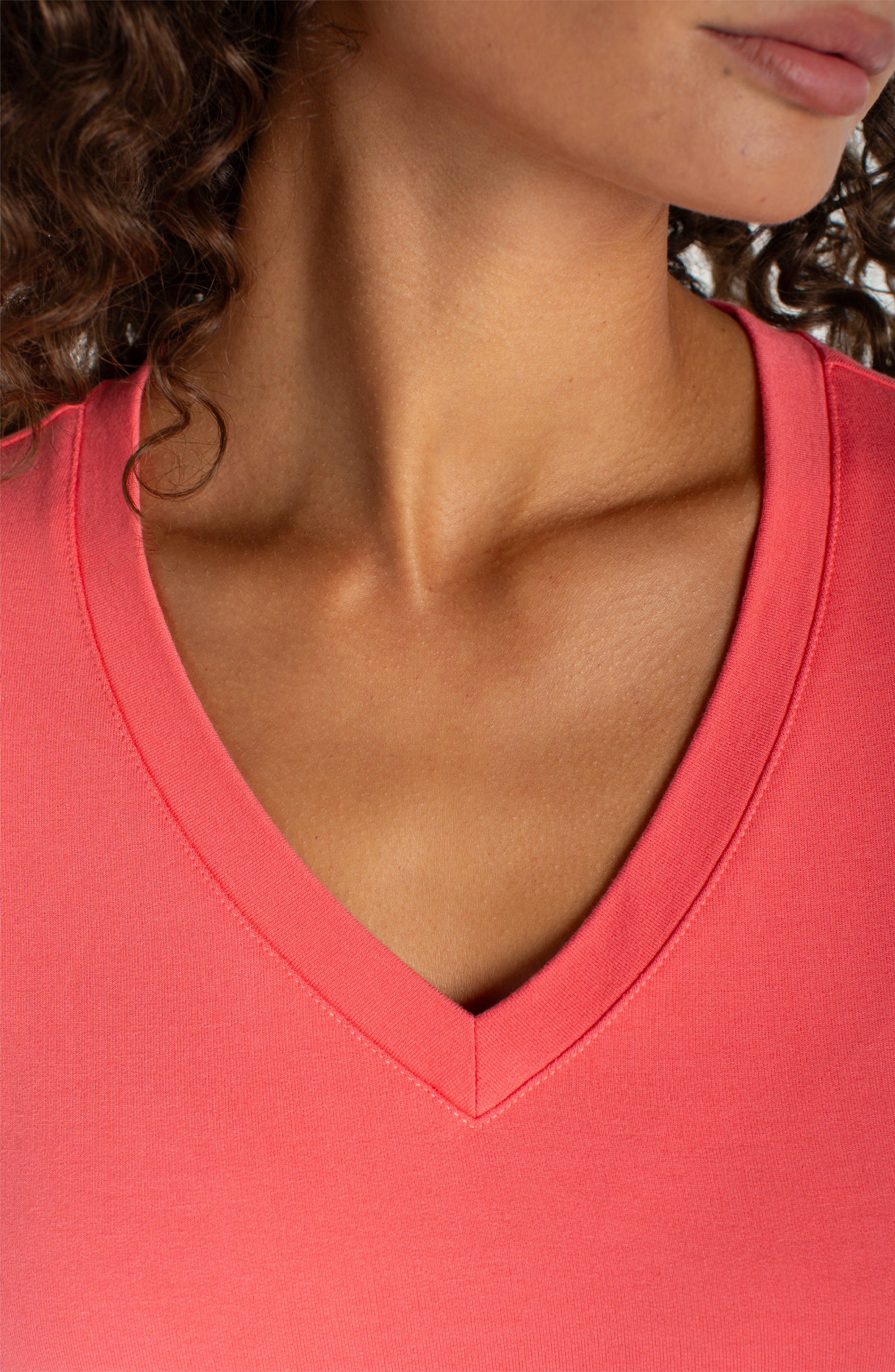 Liverpool Short Sleeve V-Neck Tee in Sunset Coral worn by female model, close-up neckline view