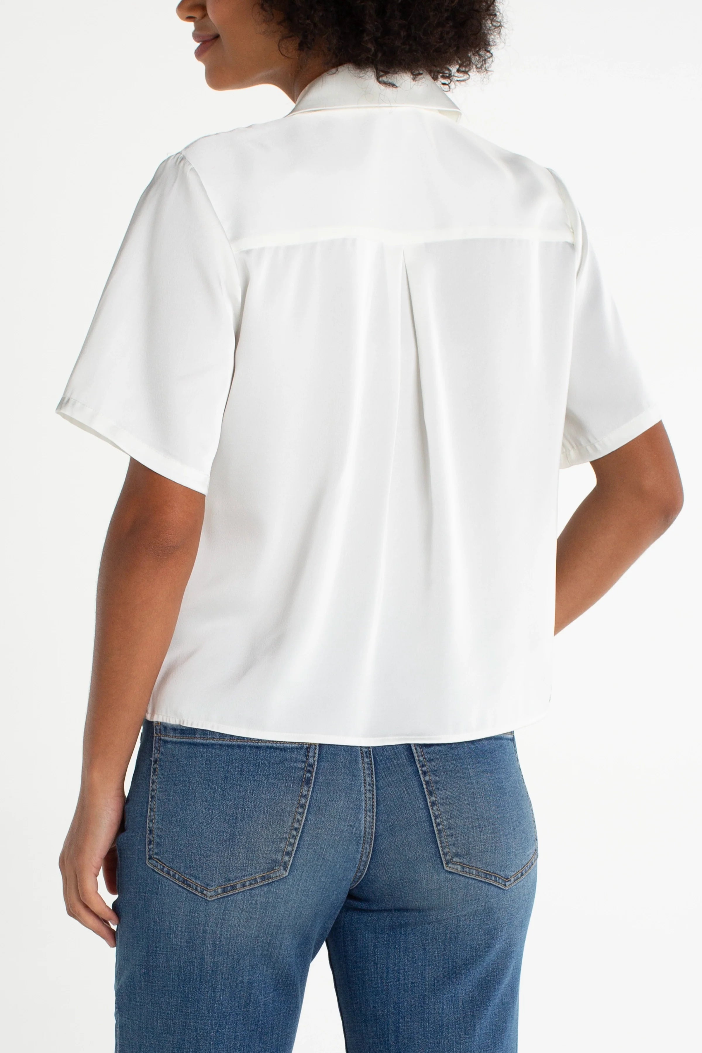 Liverpool short sleeve camp collar satin blouse in whipped cream, back view on model