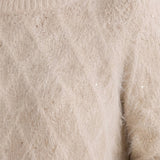 Close-up of a fuzzy boatneck sweater with scattered gold metallic sequin shimmer detail