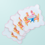 Set of four white cocktail napkins with scalloped pink edges featuring dogs playing mahjong illustration