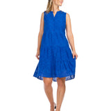Woman wearing royal blue eyelet henley dress with tiered skirt and button front