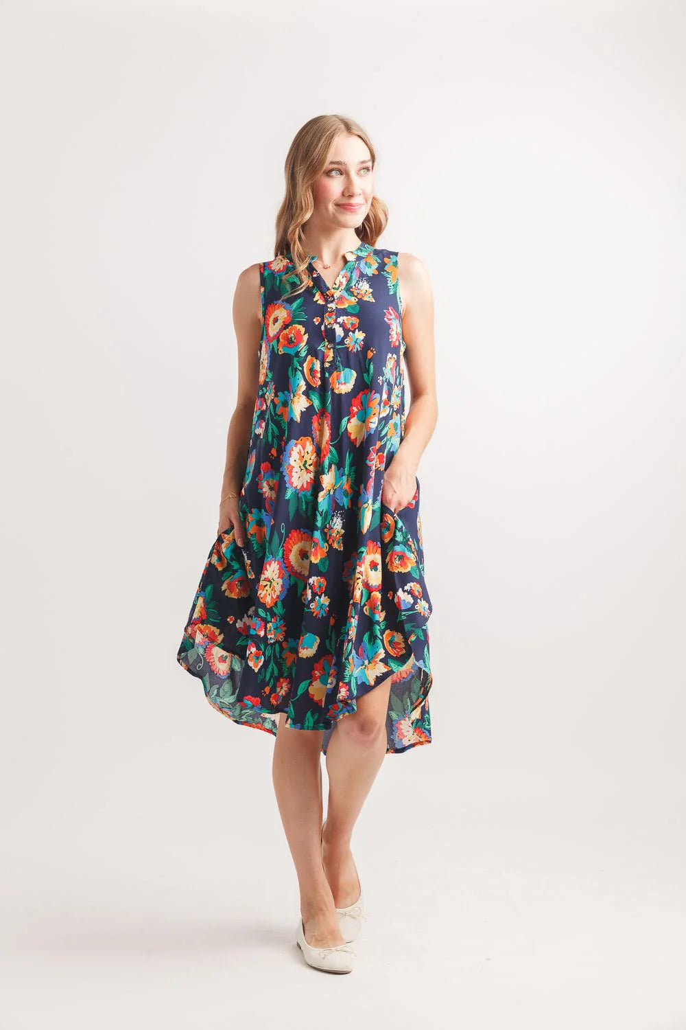 Navy floral swing dress, sleeveless Henley dress, lightweight viscose sundress, abstract print summer dress, casual floral dress with pockets, women's flowy summer fashion. at ooh la la! in Grapevine TX 76051