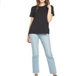 Woman wearing black bamboo tee with light blue jeans and black heels