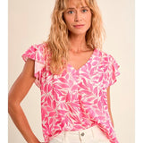 Flutter sleeve top, floral V-neck blouse, lightweight summer top, ruffled sleeve shirt, women’s botanical print top, pink floral blouse, breezy spring fashion. at ooh la la! in Grapevine TX 76051
