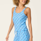 Woman wearing blue star print camisole and matching pajama pants