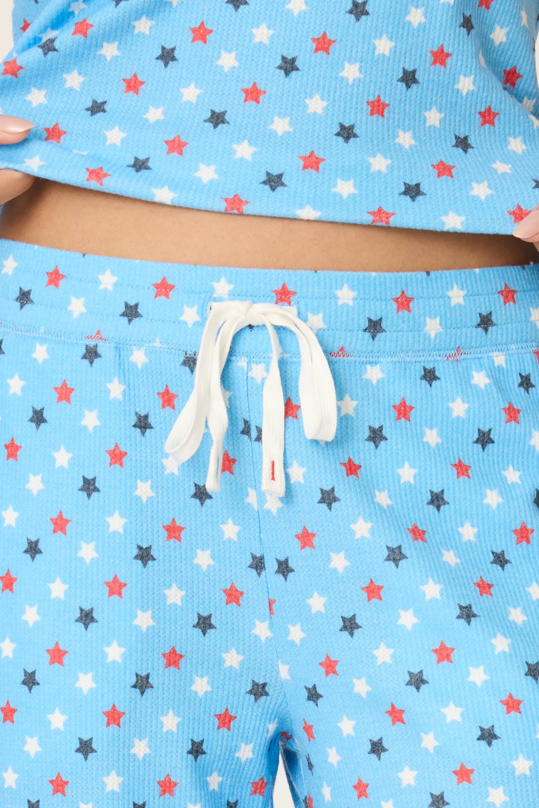 Bay blue pajama pants with patriotic red white navy star print and drawstring waist