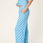 Woman wearing bay blue pajama set with patriotic star print pattern