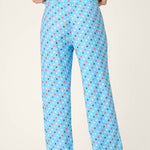 Light blue pajama pants with colorful star print pattern worn by model