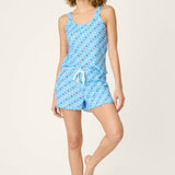 Woman wearing bay blue pajama set with colorful star print tank top and shorts