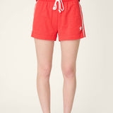 Red pajama shorts with white star detail and drawstring waistband on model