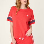Woman wearing red short sleeve top with star detail and matching red shorts