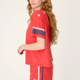 Woman wearing red star-spangled pajama set with white stars and striped details
