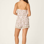 Model wearing PJ Salvage Tiki Time Short PJ Set in pink and green tropical print, back view