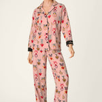 Woman wearing PJ Salvage Love Lockets pink flannel pajama set with matching hair tie