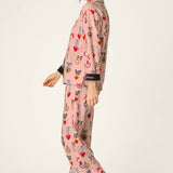 Woman wearing PJ Salvage Love Lockets pink long sleeve flannel pajama set with hearts and bows print