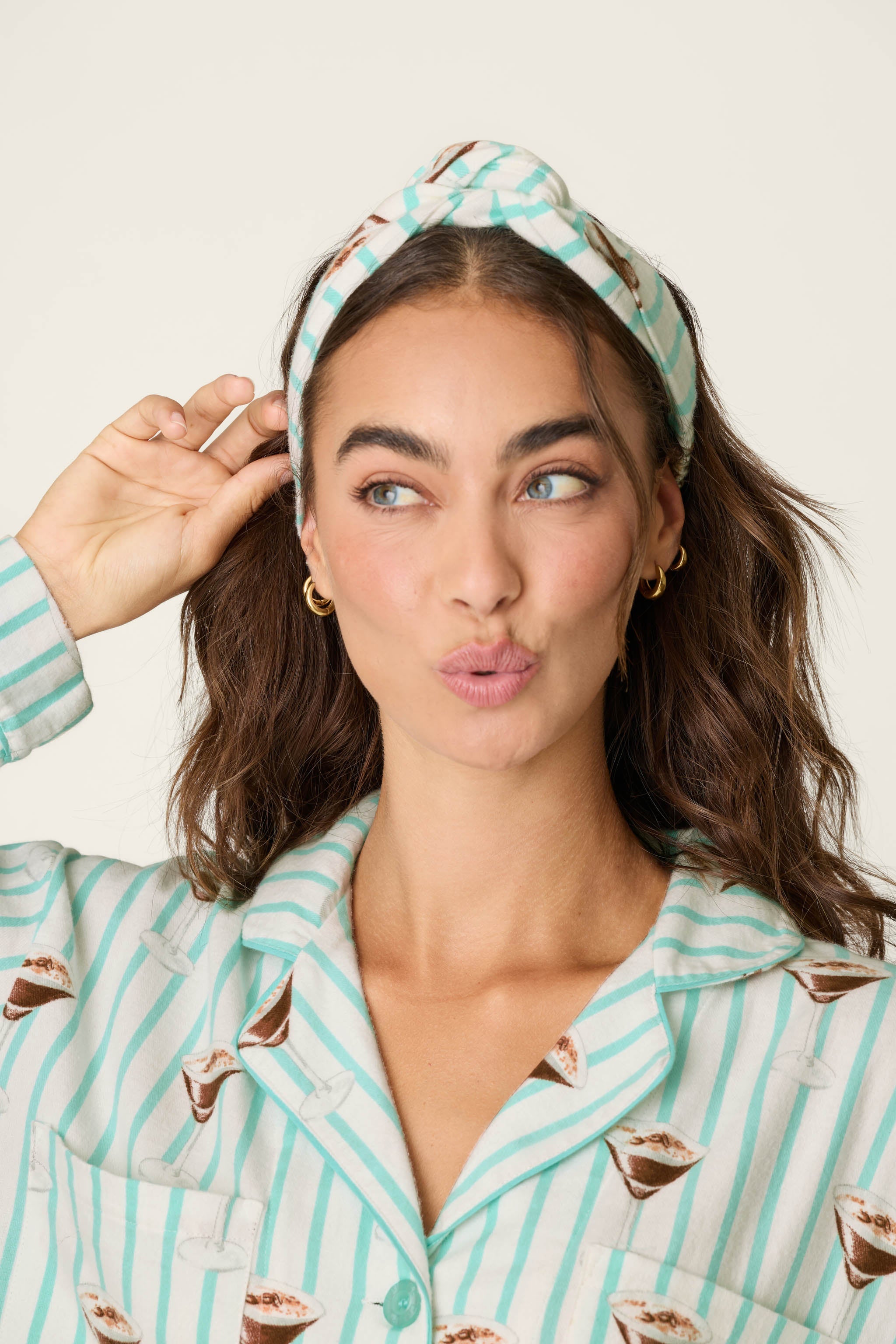 Model wearing PJ Salvage espresso martini print flannel pajama set with matching headband