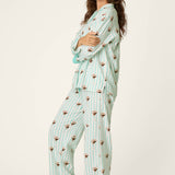 Woman wearing mint striped espresso martini print long sleeve flannel PJ set with eye mask