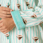Close-up of PJ Salvage flannel pajama cuff embroidered with Tipsy Time text, espresso martini print