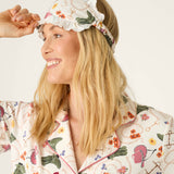 Smiling woman wearing PJ Salvage Saddle Up Western Print pajama set with matching sleep mask