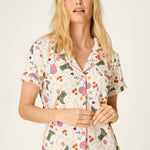 Woman wearing PJ Salvage Saddle Up Western Print cream pajama set with colorful motifs