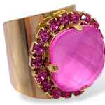 TOVA Cambrie Ring in Pink featuring large faceted hot pink stone with fuchsia crystal halo on wide gold band at ooh la la! in Grapevine TX 76051