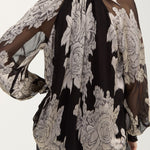 Back view of black chiffon jacquard top with floral print and sheer sleeves