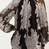 Back view of black chiffon jacquard top with floral print and sheer sleeves