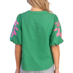 embroidered linen top, bubble sleeve blouse, green floral top, resort wear for women, v-neck summer blouse, pink and green top, botanical embroidery clothing, puff sleeve linen shirt at ooh la la! in Grapevine TX 76051