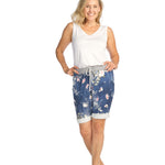 Woman wearing white bamboo v-neck tank top with floral shorts