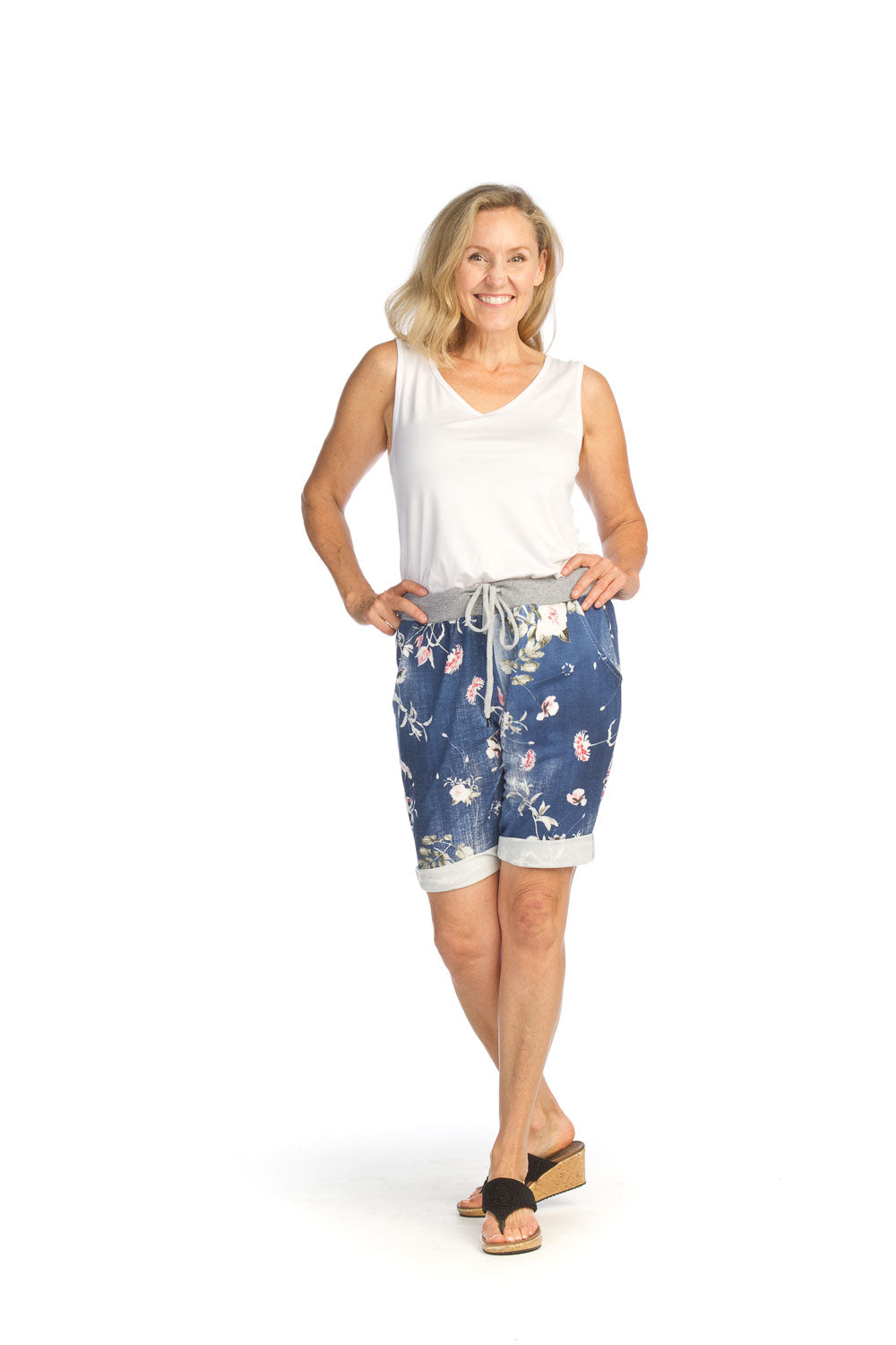 Woman wearing white bamboo v-neck tank top with floral shorts