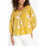 Yellow 3/4 sleeve top with cream embroidered circles and flowing lines pattern
