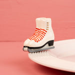 Nora Fleming Rink Ready Mini ceramic ice skate figurine with red laces on plate
